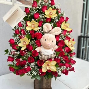 Arreglo floral con rosas, orquideas y peluche