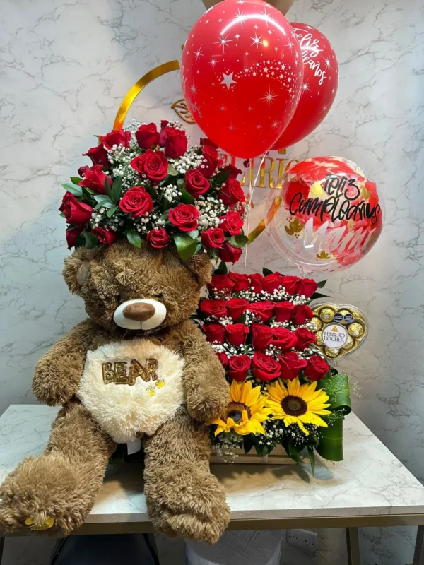 Arreglo floral con rosas, girasoles, caja corazon Ferrero Rocher, globos con helio y peluche